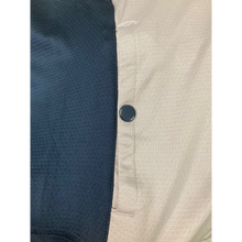 Load image into Gallery viewer, Close-up of a blue and beige textured fabric with a button.
